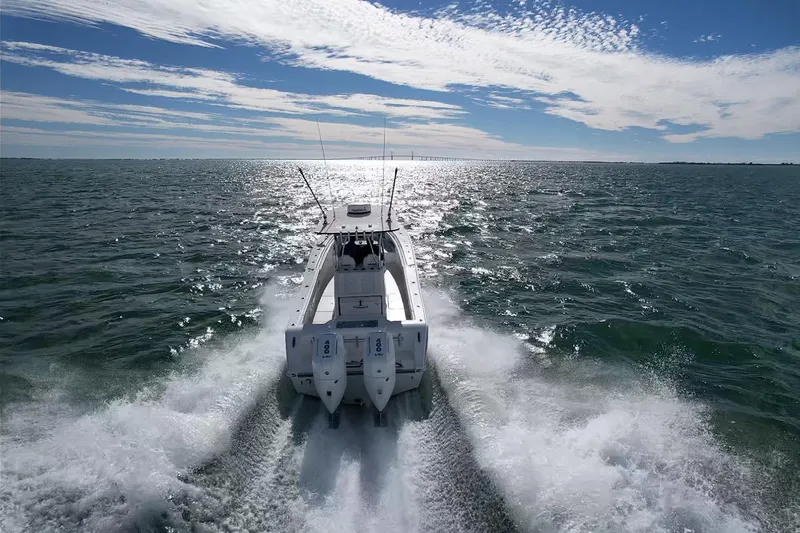 Slide: The Image of 2024 Front Runner 33 Center Console boat cruising on open water under a sunny sky. - 12