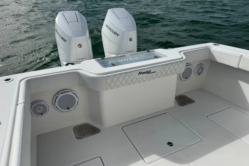 Slide: The Image of 2024 Front Runner 33 Center Console boat with dual Mercury engines on open water. - 15