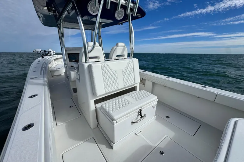 Slide: The Image of 2024 Front Runner 33 Center Console boat on open water, showcasing sleek design and seating. - 17