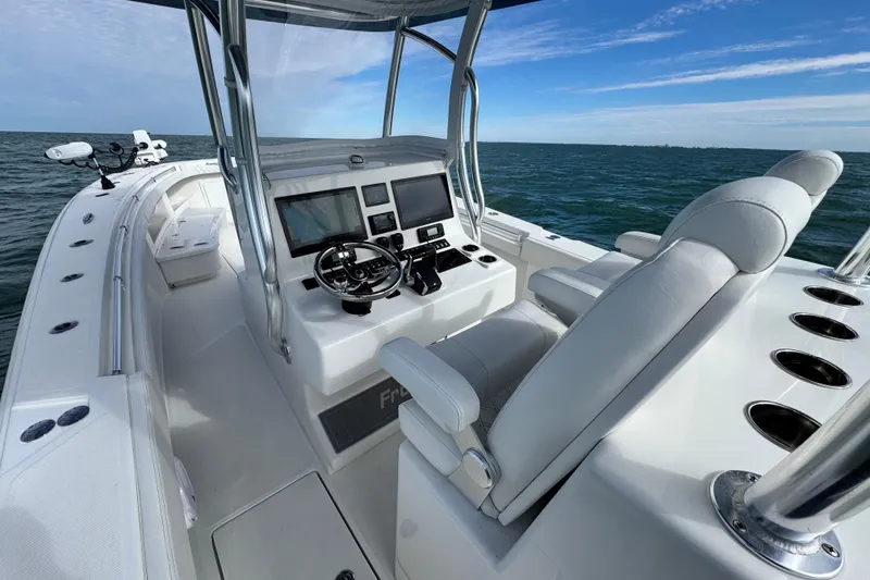 Slide: The Image of 2024 Front Runner 33 Center Console boat interior with modern helm and ocean view. - 20