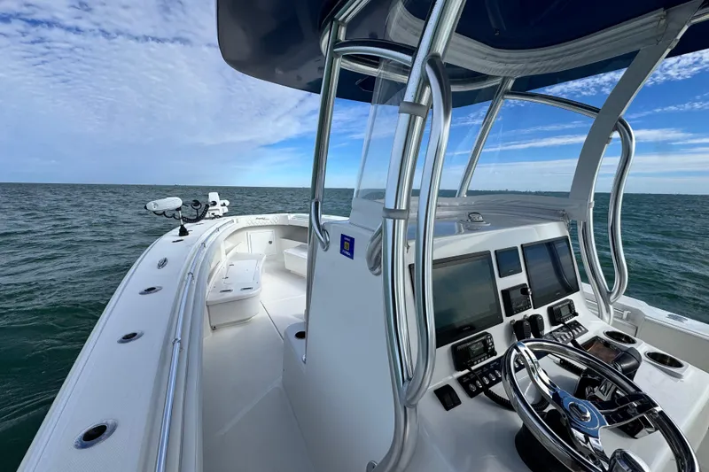 Slide: The Image of 2024 Front Runner 33 Center Console boat on open water, featuring advanced navigation controls. - 22