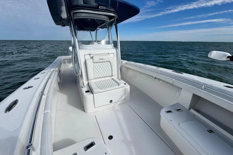 Slide: The Image of 2024 Front Runner 33 Center Console boat on open water, showcasing sleek design and seating. - 25