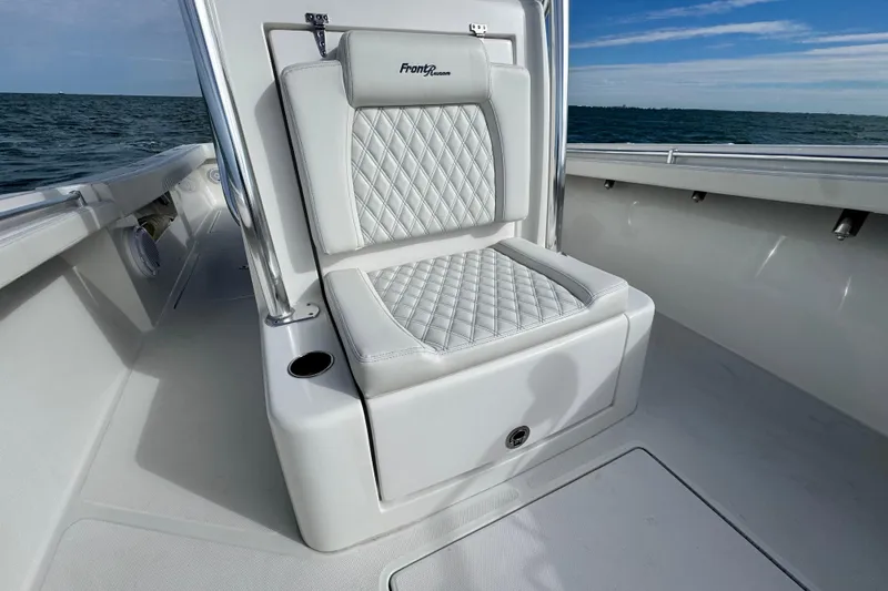 Slide: The Image of 2024 Front Runner 33 Center Console boat seat with diamond stitching, ocean view background. - 26