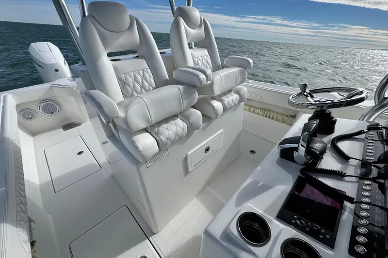 Slide: The Image of 2024 Front Runner 33 Center Console boat interior with luxurious seating and modern controls. - 27