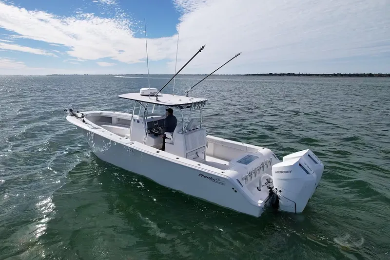 Slide: The Image of 2024 Front Runner 33 Center Console boat on open water, featuring dual Mercury engines. - 3