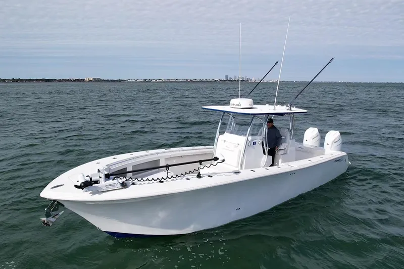 Slide: The Image of 2024 Front Runner 33 Center Console boat on open water, featuring dual engines. - 4