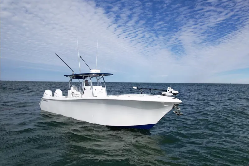 Slide: The Image of 2024 Front Runner 33 Center Console boat on open water under a blue sky. - 5
