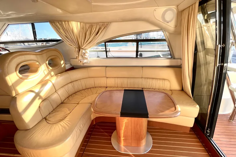 Slide: The Image of Luxurious interior of 2003 Cranchi Atlantique 40 yacht with elegant seating and wooden table. - 10
