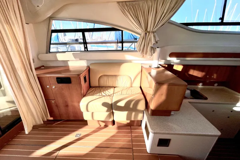 Slide: The Image of Luxurious interior of 2003 Cranchi Atlantique 40 yacht with leather seating and wooden cabinetry. - 11