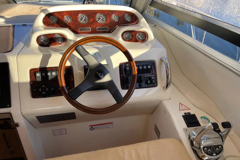 Slide: The Image of 2003 Cranchi Atlantique 40 yacht helm with wood accents and modern controls. - 12