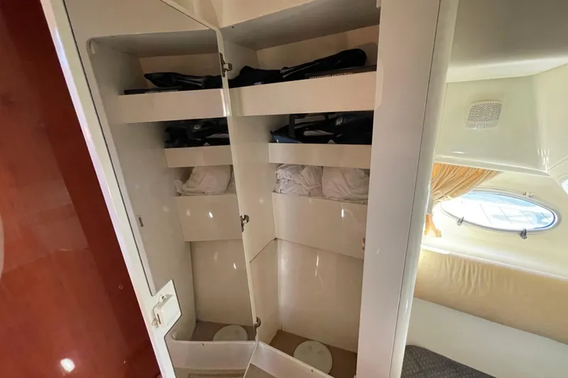 Slide: The Image of Interior storage of 2003 Cranchi Atlantique 40 yacht with shelves and porthole view. - 17