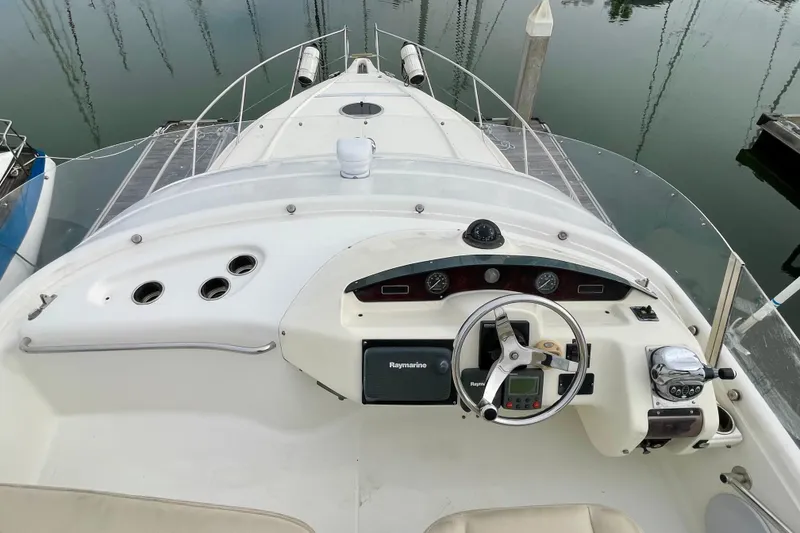Slide: The Image of 2003 Cranchi Atlantique 40 yacht helm with steering wheel and navigation instruments. - 19