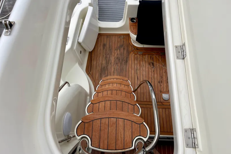 Slide: The Image of Staircase on 2003 Cranchi Atlantique 40 yacht with wooden deck and seating area. - 23