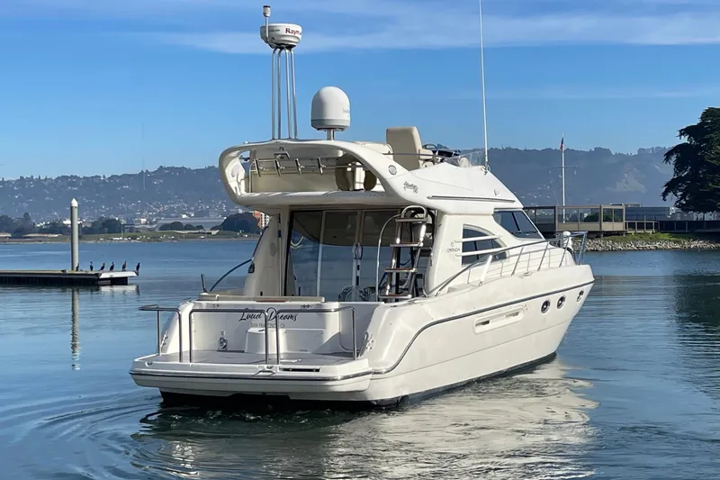 Slide: The Image of 2003 Cranchi Atlantique 40 yacht on calm water with scenic background. - 4