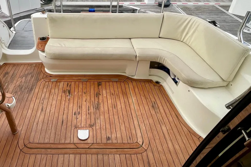 Slide: The Image of Luxurious 2003 Cranchi Atlantique 40 yacht with elegant teak deck and cushioned seating area. - 8