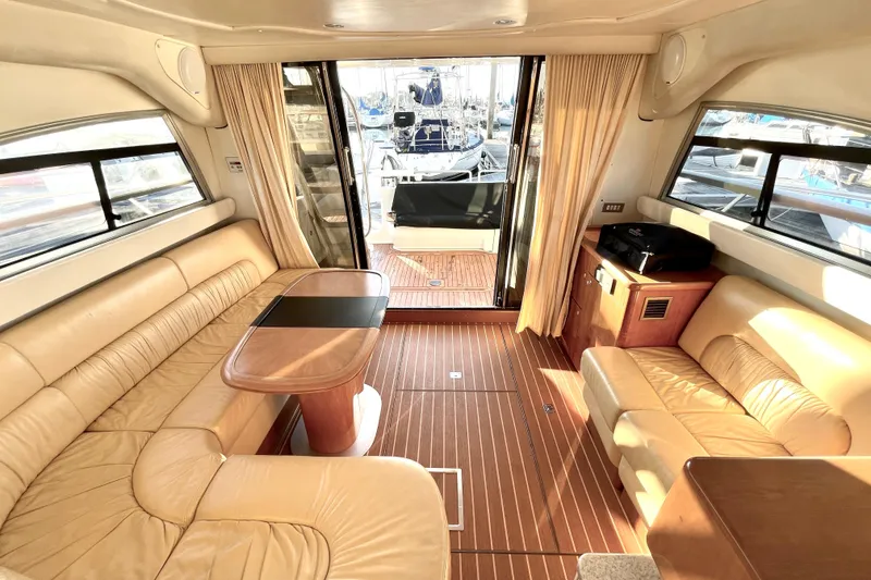 Slide: The Image of Luxurious interior of 2003 Cranchi Atlantique 40 yacht with leather seating and wooden flooring. - 9
