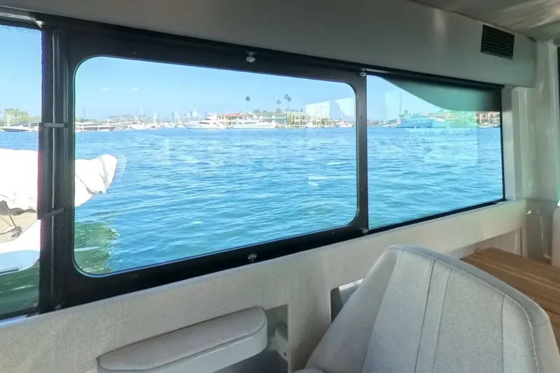 Slide: The Image of Interior view from 2024 Saxdor 320 GTC, showcasing marina through large window. - 52