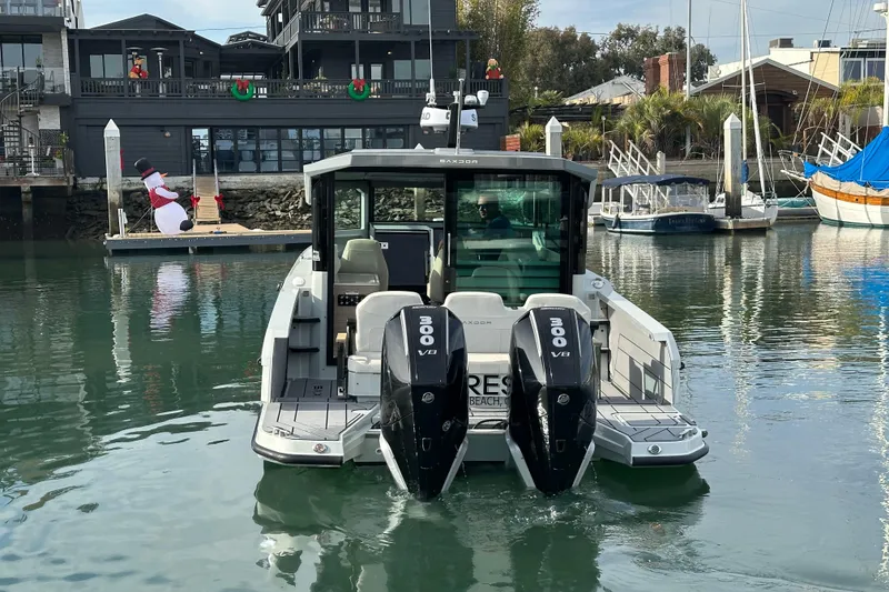 Slide: The Image of 2024 Saxdor 320 GTC boat with dual 300 V8 engines docked in a marina. - 58