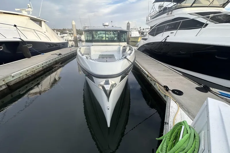 Slide: The Image of 2024 Saxdor 320 GTC boat docked between two yachts in a marina. - 60