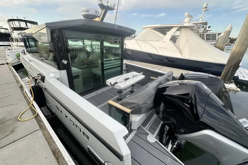 Slide: The Image of 2024 Saxdor 320 GTC boat docked, showcasing sleek design and modern features. - 64