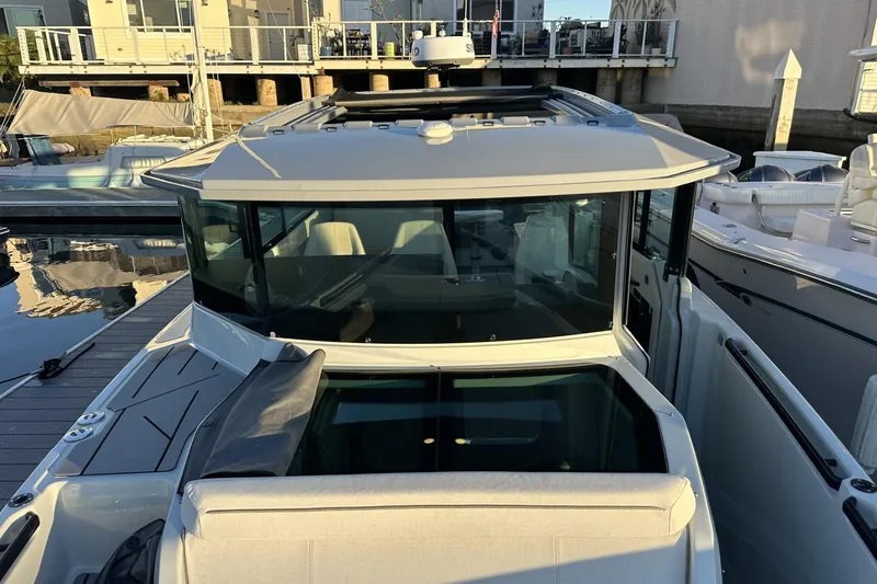 Slide: The Image of 2024 Saxdor 320 GTC boat docked, showcasing sleek design and modern features. - 66