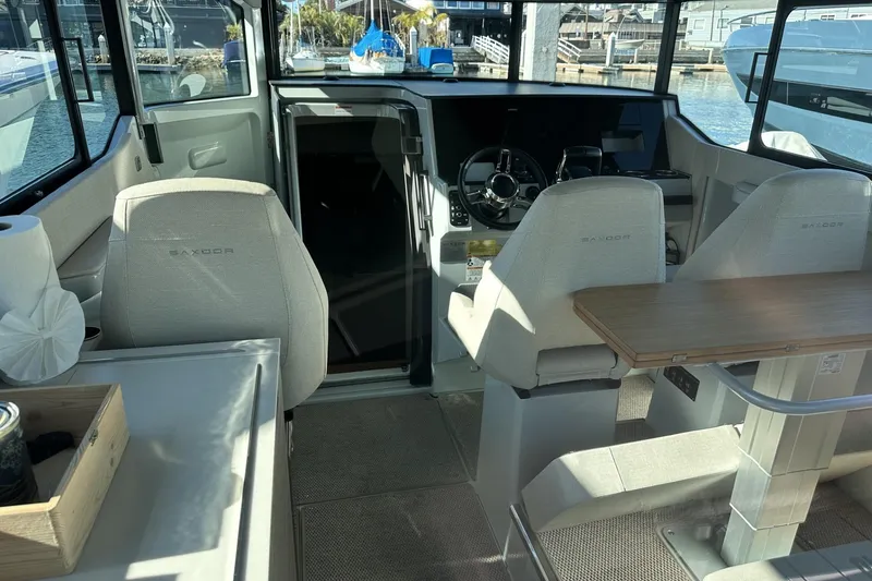 Slide: The Image of Interior of 2024 Saxdor 320 GTC boat with modern seating and steering area. - 67