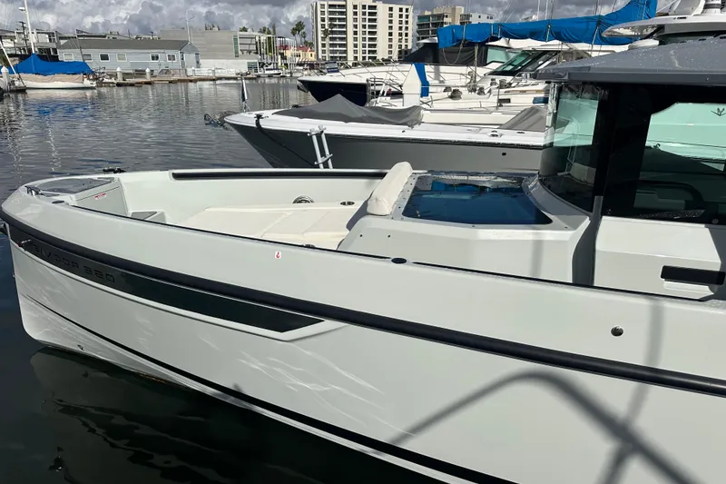Slide: The Image of 2024 Saxdor 320 GTC boat docked in a marina, showcasing sleek design and modern features. - 73