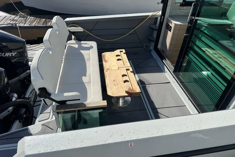 Slide: The Image of 2024 Saxdor 320 GTC boat interior with seating and wooden table on deck. - 74