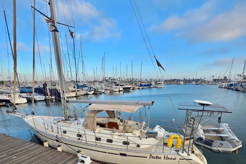 The Image of 2008 Caliber center cockpit cutter sailboat docked in a marina under a clear blue sky. - 0