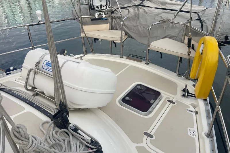 Slide: The Image of 2008 Caliber center cockpit cutter docked among luxury yachts at marina. - 12