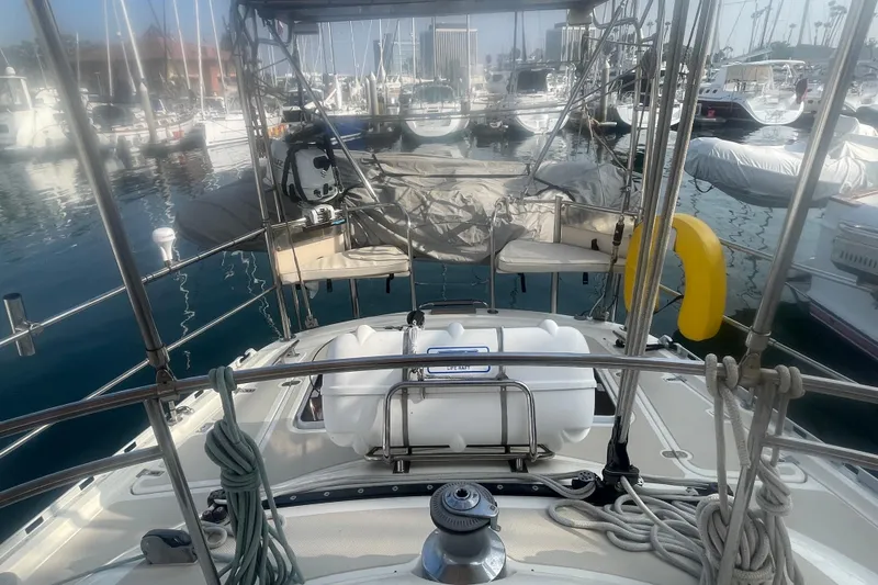 Slide: The Image of 2008 Caliber 47 LRC yacht docked in marina, surrounded by sailboats and clear blue water. - 18