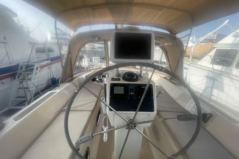Slide: The Image of 2008 Caliber 47 LRC yacht with dinghy in marina, surrounded by boats and clear blue water. - 19