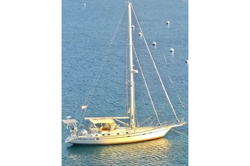 Slide: The Image of 2008 Caliber 47 LRC sailboat docked at marina under clear blue sky. - 2
