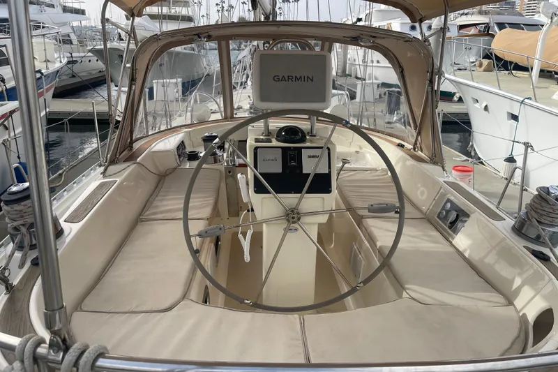 Slide: The Image of 2008 Caliber center cockpit cutter with covered equipment and Suzuki outboard motor at marina. - 23