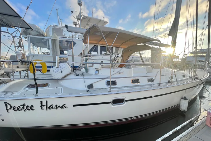 Slide: The Image of 2008 Caliber 47 LRC sailboat docked at marina, sun setting in background. - 3