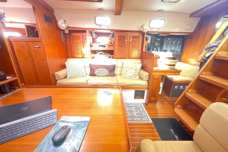 Slide: The Image of 2008 Caliber 47 LRC sailboat docked in marina, surrounded by other boats and palm trees. - 30