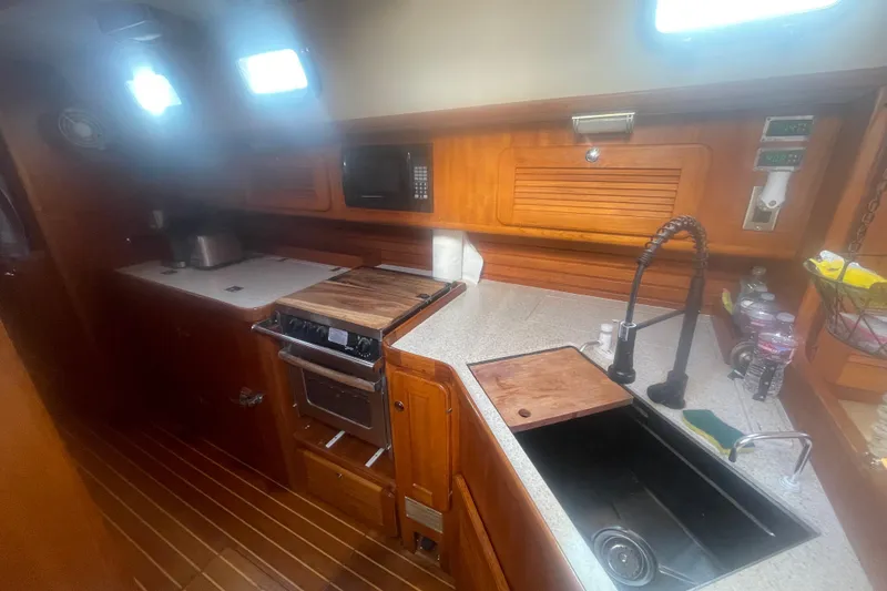 Slide: The Image of 2008 Caliber center cockpit cutter kitchen with wooden cabinetry and modern appliances. - 43