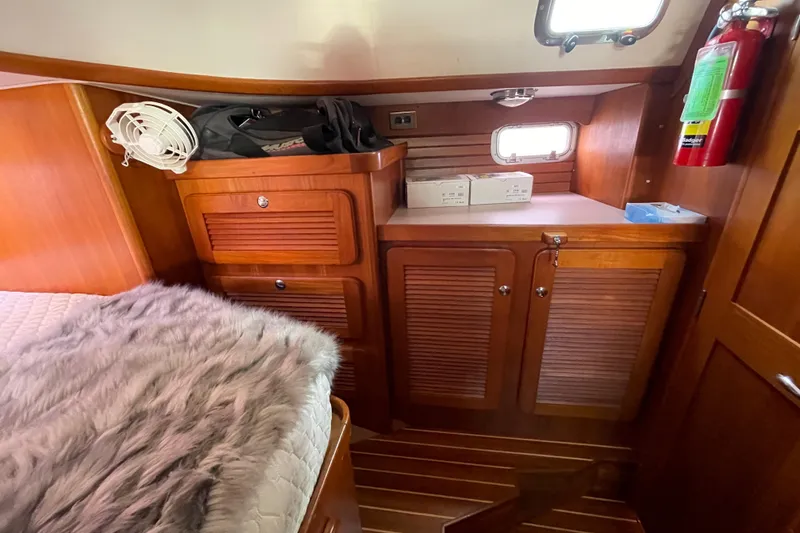 Slide: The Image of Luxurious 2008 Caliber 47 LRC yacht cabin with cozy bed and wooden interior. - 49