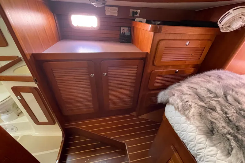 Slide: The Image of Luxurious cabin interior of 2008 Caliber center cockpit cutter with cozy bedding and wood finish. - 50
