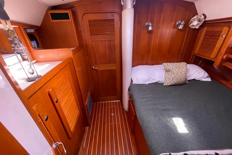 Slide: The Image of Luxurious 2008 Caliber 47 LRC yacht cabin with cozy bedding and elegant wood finish. - 52