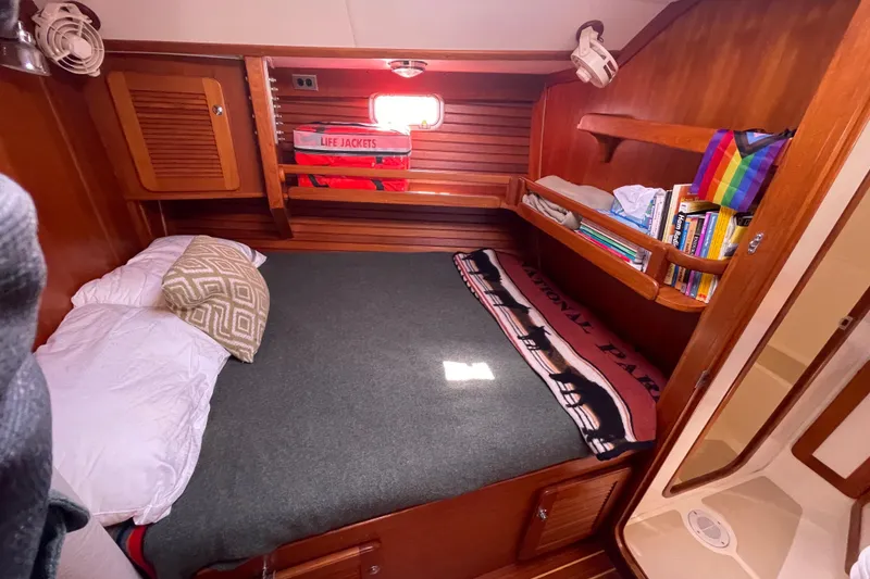 Slide: The Image of Cozy cabin interior of 2008 Caliber center cockpit cutter with plush bedding and wooden furnishings. - 53