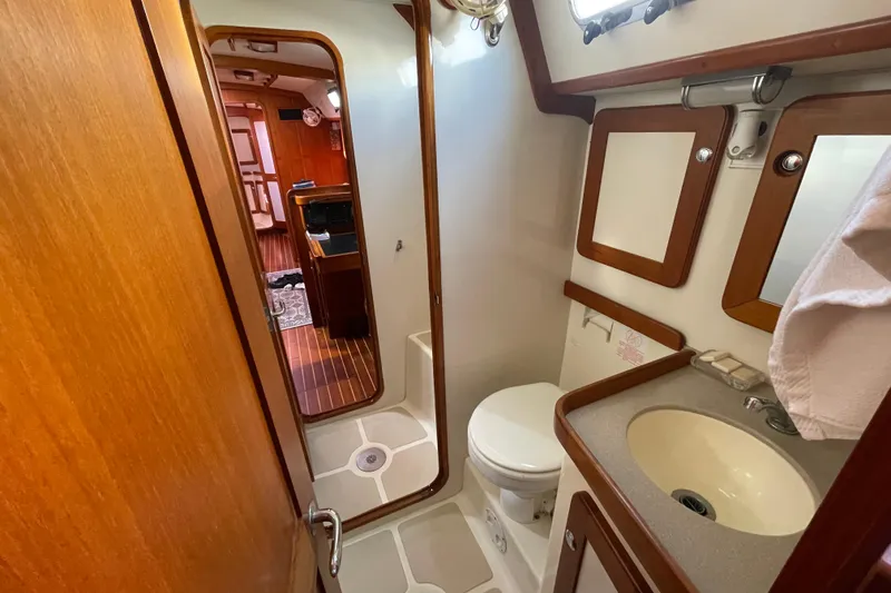 Slide: The Image of Cozy cabin interior of 2008 Caliber center cockpit cutter with plush bedding and wooden cabinetry. - 55