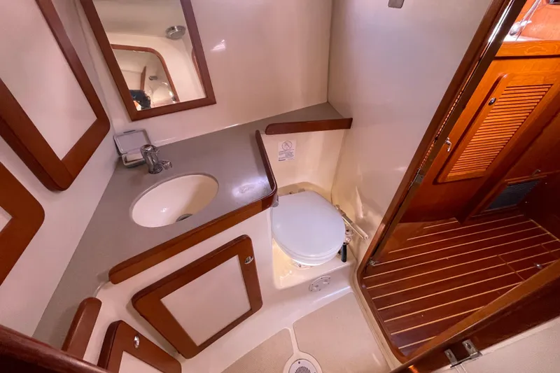Slide: The Image of Cozy cabin interior of 2008 Caliber center cockpit cutter with wooden cabinetry and bedding. - 56