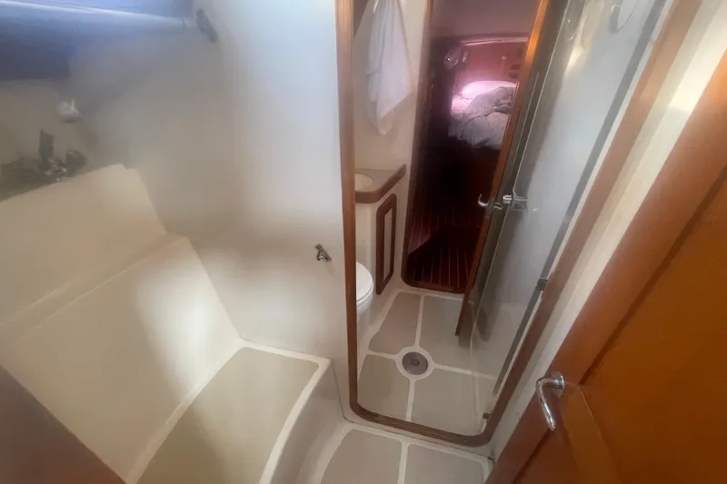 Slide: The Image of Interior of 2008 Caliber center cockpit cutter with wooden cabinetry and cozy bedding. - 57