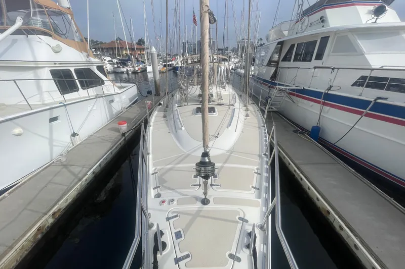 Slide: The Image of 2008 Caliber center cockpit cutter yacht docked at marina, clear sky background. - 6