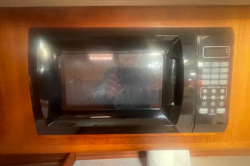 Slide: The Image of 2008 Caliber center cockpit cutter bathroom with sink, toilet, and wooden accents. - 64