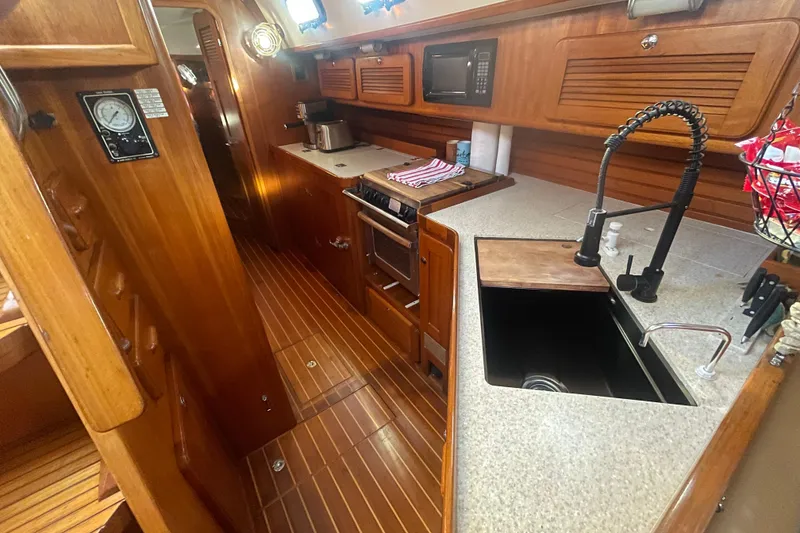 Slide: The Image of Luxurious 2008 Caliber 47 LRC yacht kitchen with wood cabinetry and modern appliances. - 71