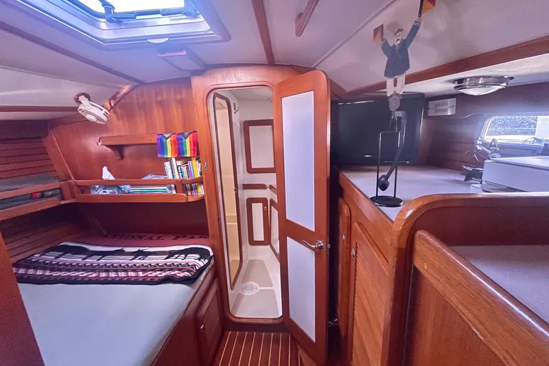 Slide: The Image of Cozy interior of 2008 Caliber 47 LRC yacht with wooden finishes and a small bed. - 74