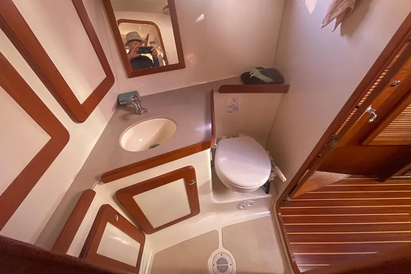 Slide: The Image of 2008 Caliber 47 LRC yacht bathroom with sink, toilet, and wooden accents. - 75