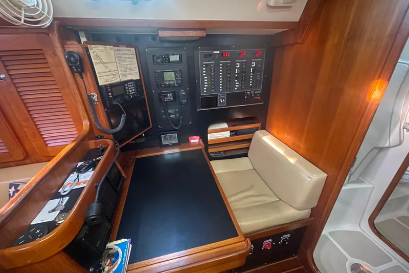 Slide: The Image of Navigation station of 2008 Caliber 47 LRC yacht with control panels and seating. - 76